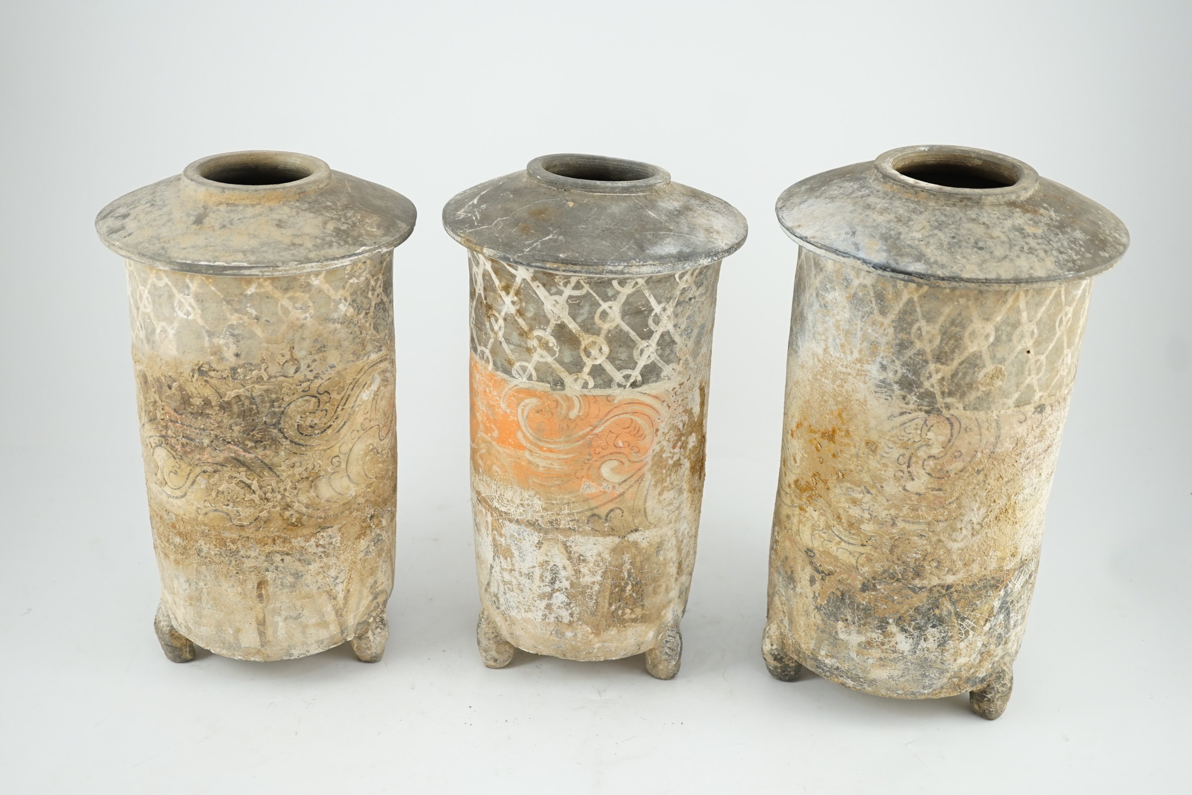 Three Chinese pigment painted grey pottery ‘granary’ jars, Han dynasty (200BCE - 220CE), 29.5 and 32cm high